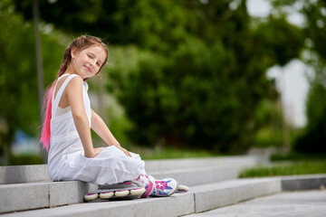 cute little girl on roller skates at park.
