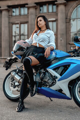Plakat Shot of woman with motorbike in summertime outside