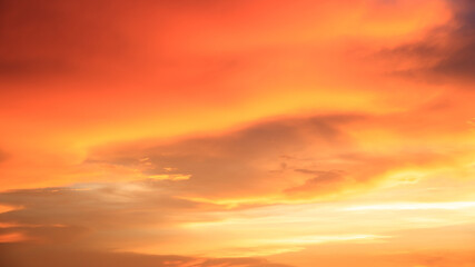 Background of orange sky and clouds with sunset light in evening at summer time when with blank copy space, showing about environment, climate concept.