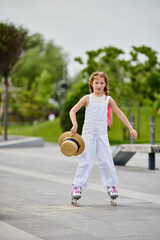 Cute little child girl on roller skates at park