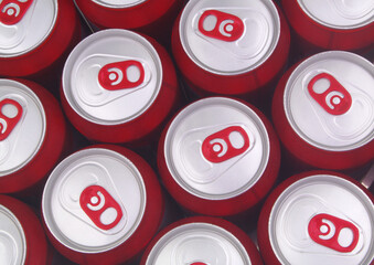 Red drink tin cans background, top view