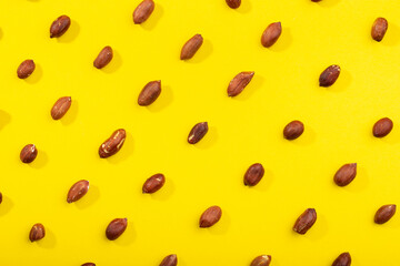Peanuts pattern isolated on a yellow backround. Repetition concept.