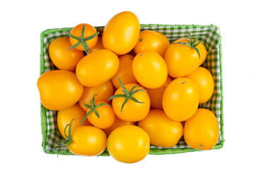 Yellow tomatoes in a basket isolated on white background. Diet food. Fresh and healthy vegetables. Top view.