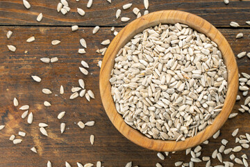 sunflower seeds in wooden bowl.