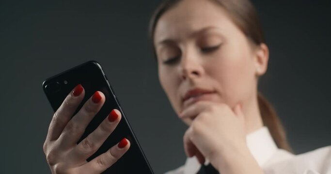 Dissatisfied european woman swipes the screen of smartphone in a rush, user declines meassages and apps in mobile phone, angry office worker uses phone, 4k Prores HQ 10 bit