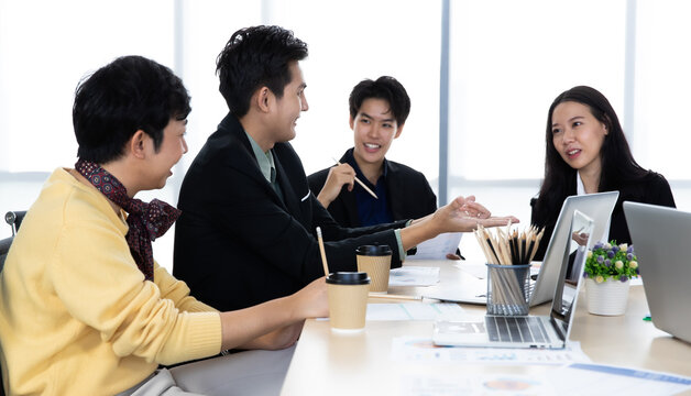 A Group Of Multi Sex Colleagues, Tomboy, Transgender And Lesbian Businesspeople Working Together With Happy And Intimate Manner. Teamwork And Unity Of Workplace Concept