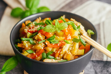 Turkey with vegetables. Delicious hot dish on a concrete table. Turkey with vegetables in a plate