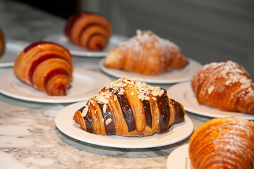 Several croissants are placed on the marble table before serving