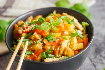 Turkey with vegetables. Delicious hot dish on a concrete table. Turkey with vegetables in a plate