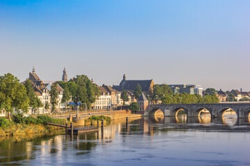 Historic Servaas bridge over river Maas at dawn in Maastricht, Netherlands