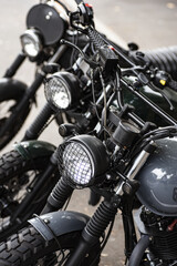 Closeup shot of a handlebar of a  black motorcycle  in the street
