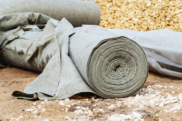Geotextile in a roll lies on a construction site. Strengthening the soil with building tissue....