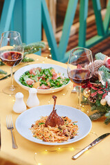 Baked duck leg on a festive Christmas table. Space for text. High quality photo