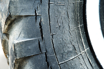 Fragment of a truck tire with cracks and rupture of rubber. Close-up