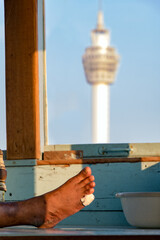 The look at the observation tower through window of wheelhouse at ferry sailing on Chao Phraya river, Samut Prakan, Thailand. © milkovasa