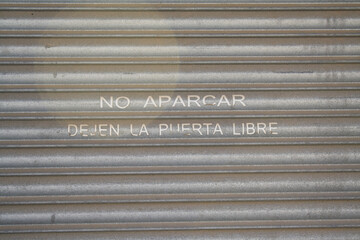 no parking on a metal gate sign