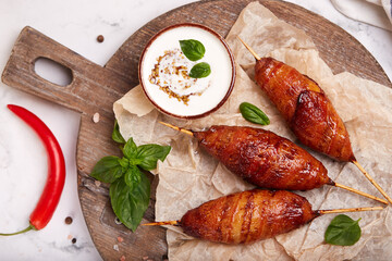 Chicken Lula kebab wrapped in slices of bacon served with yoghurt sauce with mustard. Minced meat...
