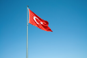  Rippling Turkish Flag on windy blue sky background.