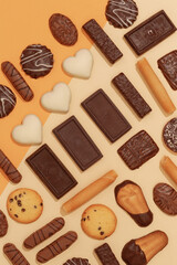 Fototapeta na wymiar Chocolate cookies mix background. Sweets choco lover design. Minimal art. Holidays time, winter christmas celebration concept