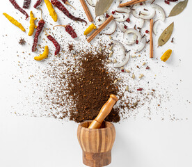 Assorted Indian spice garam masala and herbs on white background top angle view