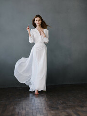Woman in white dress posing glamor studio