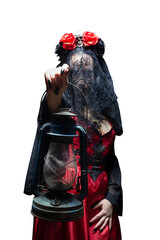 Isolated mysterious sorceress or witch in red gothic dress, black veil and crown with skull and roses reaching out her hand with ancient lantern. Halloween concept.