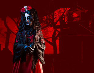 Mysterious woman with Santa Muerte makeup in shawl and crown with skull and roses on stylized cemetery background. Halloween concept.