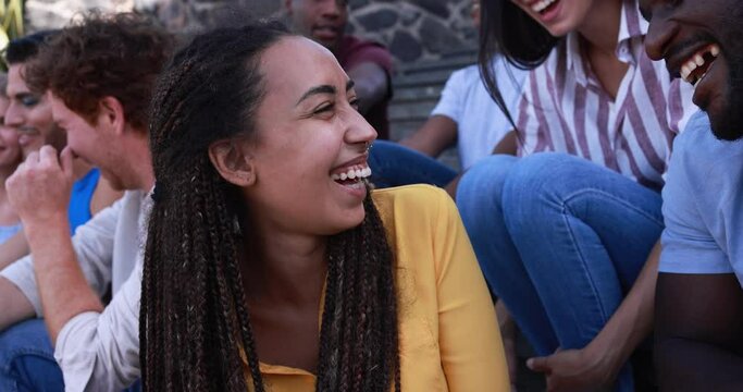 Group of diverse young people having fun in the city while using smartphone - Young multiracial friends outdoor 