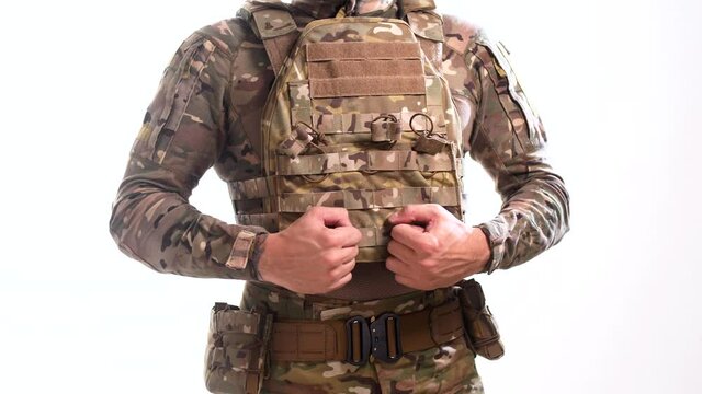 Special Forces soldier in camouflage in multicam and plate carrier rotates 180 degrees on a white background