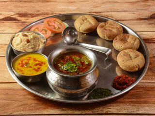 Rajasthani Traditional Cuisine Dal Baati Also Know as Dal Bati or Daal Baati Churma on Wooden Background. selective focus