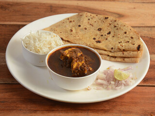 Veg Thali from an indian cuisine, food platter consists paneer curry,rice,roti,onions etc., selective focus