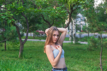 portrait of a teenager, long-haired girl 16 years old with brown hair on a background of nature