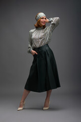 full length portrait of a fashionable aged woman isolated on grey