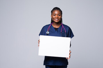 African doctor woman, medical professional working holding blank advertising banner, good poster...