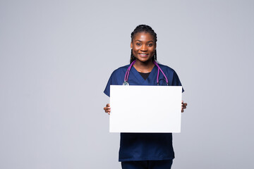African doctor woman, medical professional working holding blank advertising banner, good poster...