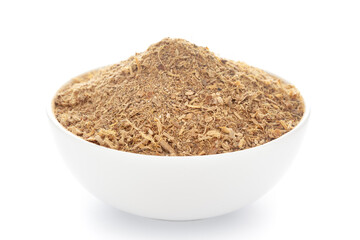 Close-up of organic  ayurvedic herbal tea powdered mixture in a white ceramic bowl over white background.