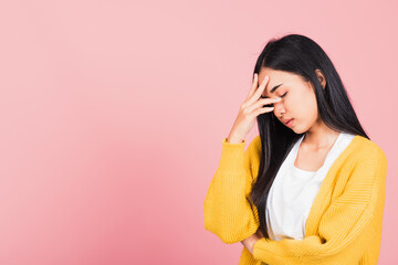 Portrait of beautiful Asian young woman sad tired strain face holding hold head by hands, female person closed eyes problem she headache, studio shot isolated on pink background - obrazy, fototapety, plakaty