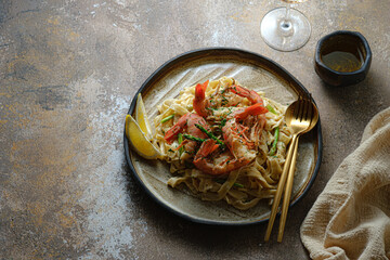 Tagliatelle pasta with huge prawn in cream sauce, dark photo