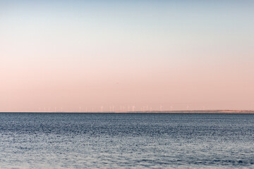 sunset sun by the ocean, clear water and sandy azure beach