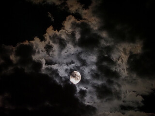 Naklejka na ściany i meble moon light behind clouds