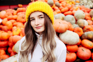 Young pretty woman holding orange halloween pumpkin. 