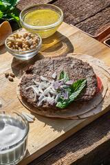 Spicy lamb kebab patties served with mint dip, crunchy salad, pitta bread and raw red onions.