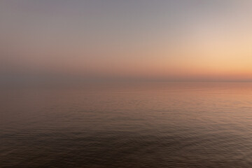 sunset sun by the ocean, clear water and sandy azure beach