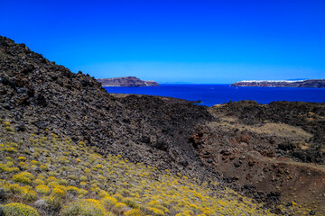 Views from volcano island Nea Kameni. Santorini - officially Thira and classic Greek Thera is an...