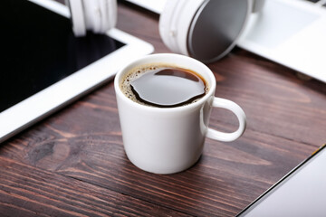 Cup of coffee on wooden background