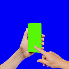 Female finger typing on mobile phone green screen in her hands, the device is positioned slightly turned