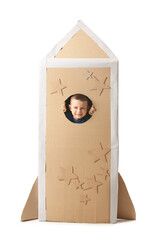 Cute little boy playing with cardboard rocket on white background