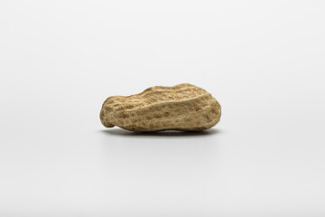 Single boiled peanut on isolated white background.