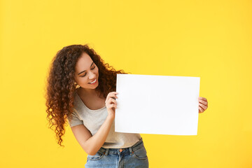 Fototapeta na wymiar Young woman with blank poster on color background