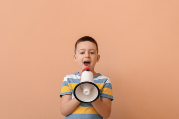 Little boy with megaphone training pronounce letters on color background